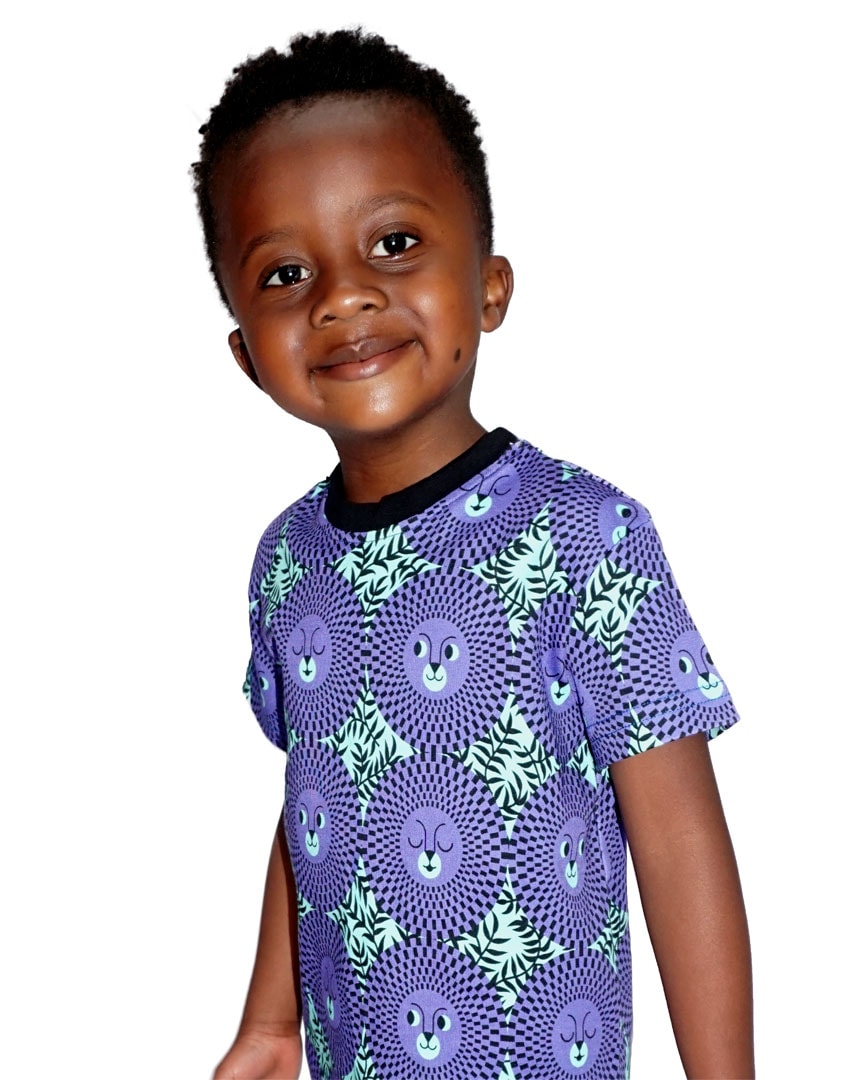 Little boy wearing vibrant green/purple African inspired lion face t-shirt